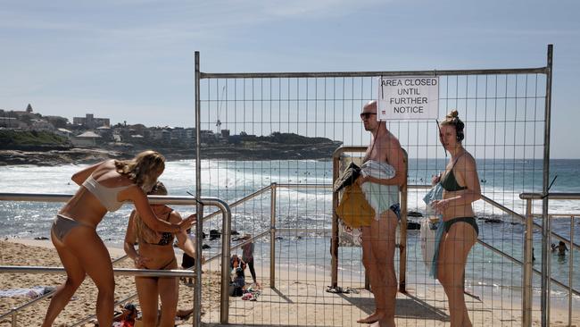 Beachgoers ignore “beach closed” signs at Bronte Beach last week. Picture: Jane Dempster