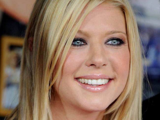 American actor Tara Reid poses for photographs at the American Pie: Reunion media call in front of the iconic Harry's Cafe de Wheels, Sydney, Tuesday, March. 6, 2012. American Pie: Reunion opens on April 5. (AAP Image/Tracey Nearmy) NO ARCHIVING