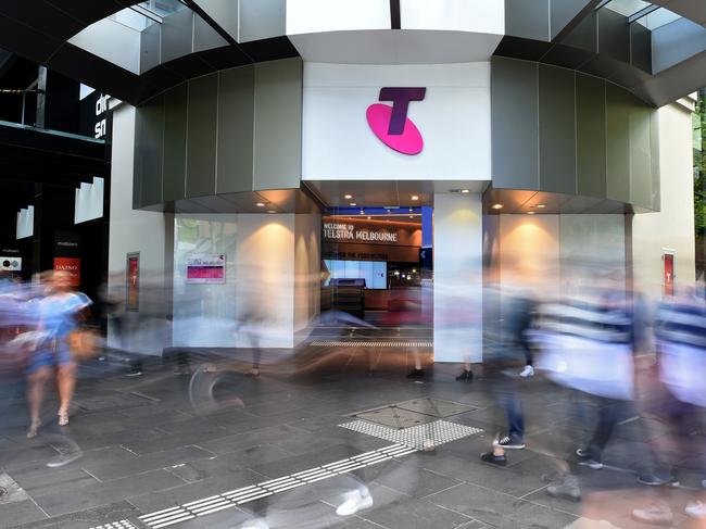 Pedestrians walk past a Telstra Corp. Discovery store in Melbourne, Australia, on Tuesday, Feb. 9, 2016. Telstra, Australia's biggest phone company, is scheduled to report half-year results on Feb. 18. Photographer: Carla Gottgens/Bloomberg