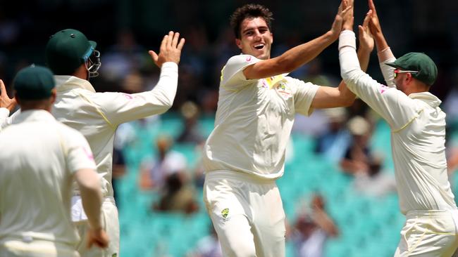 Australian players celebrate after Pat Cummins takes the wicket of England’s Mason Crane on Monday.