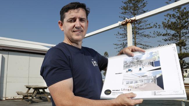 Property owner Mark Lawson at the old Wynnum Seafood site, shows the sketch for the proposed hotel and microbrewery development. Picture: AAP Image/Regi Varghese