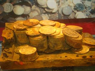 Treasure trove ... Gold and the remains of a wooden cargo box unearthed from the SS Central America is shown at a coin collection expo in Long Beach, California. Source: AP