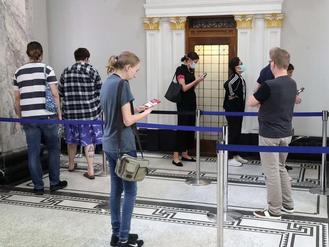 Pre-poll voters practise social distancing at Brisbane City Hall. Picture: Liam Kidston