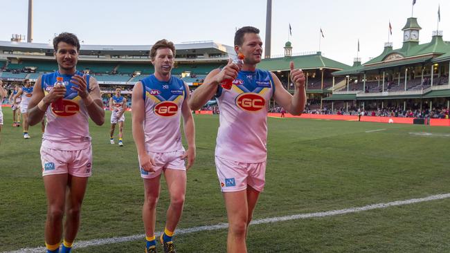 A happy Steven May leads his Suns teammates off the SCG. Picture: AAP