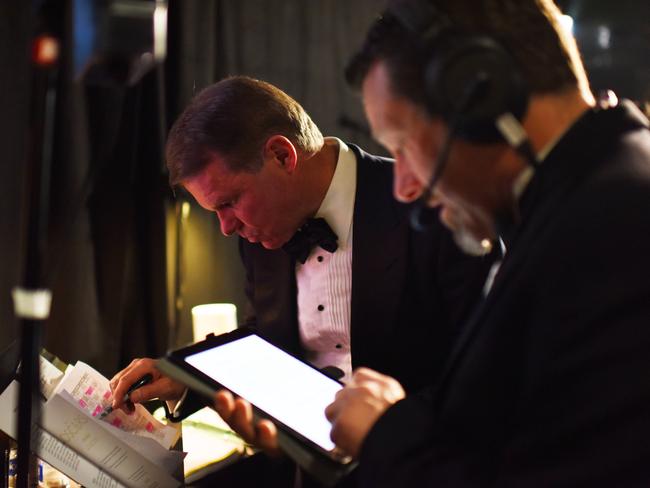 Cullinan studies a run sheet backstage. Picture: Rex Features / Splash News
