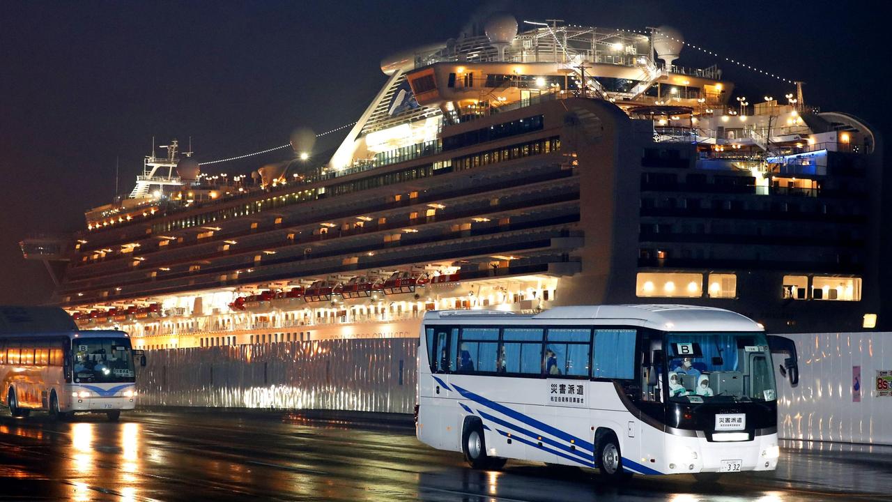 Buses carrying American passengers leave Yokohama port early on Monday. Picture: Jun Hirata/Kyodo News via AP