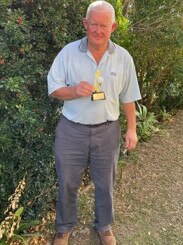 VETS GOLF: Rohan Braithwaite proudly displays his hole in one trophy.