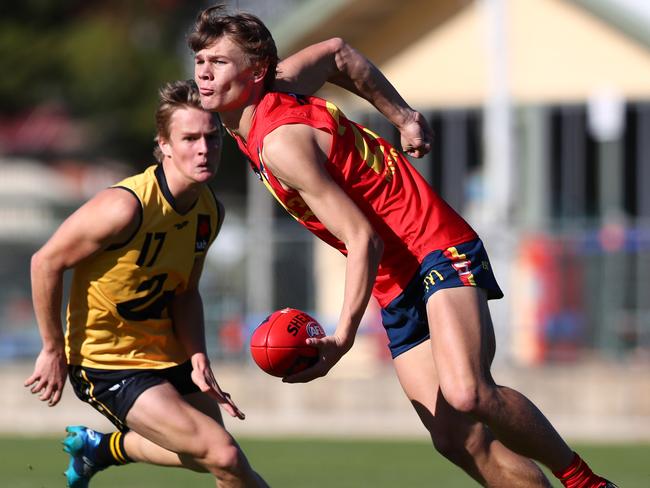 Aaron Nietschke gets a handball away.