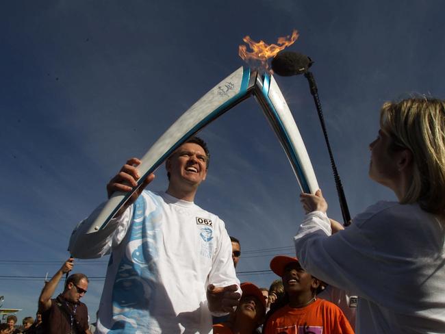 September 4, 2000: Olympics Minister Michael Knight transfers the flame in Campbelltown during Penrith to Bowral leg of Sydney 2000 Olympic Torch Relay. Picture: Glen Campbell