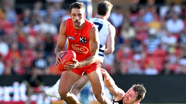 Ben Long breaks away from the defence of the Cats’ Patrick Dangerfield during Gold Coast’s round three win against Geelong. Picture: Bradley Kanaris/Getty Images