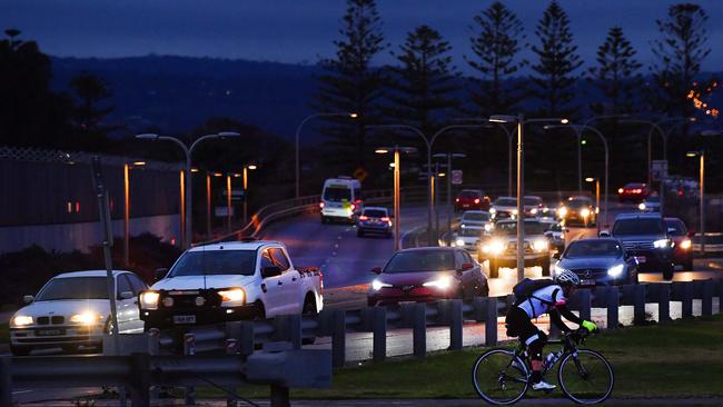 Early morning traffic on Tapleys Hill Road at West Beach. Photo: AAP/Mark Brake