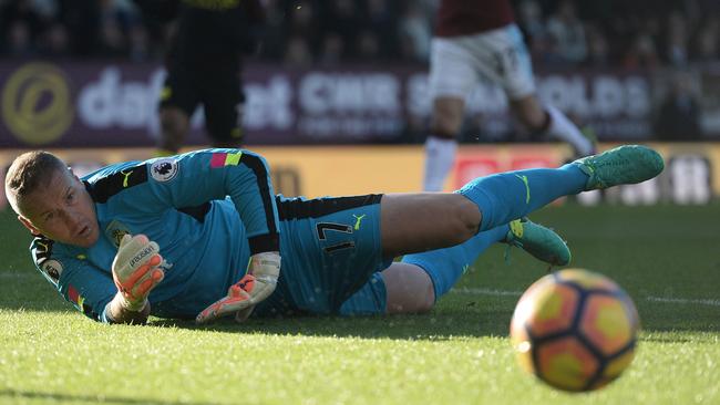 Burnley's English goalkeeper Paul Robinson makes an early save.