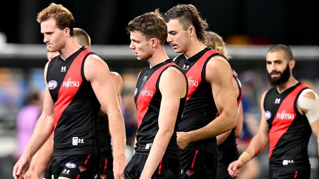 Essendon players leave the field after their heavy loss to Geelong. Picture: Bradley Kanaris/Getty Images