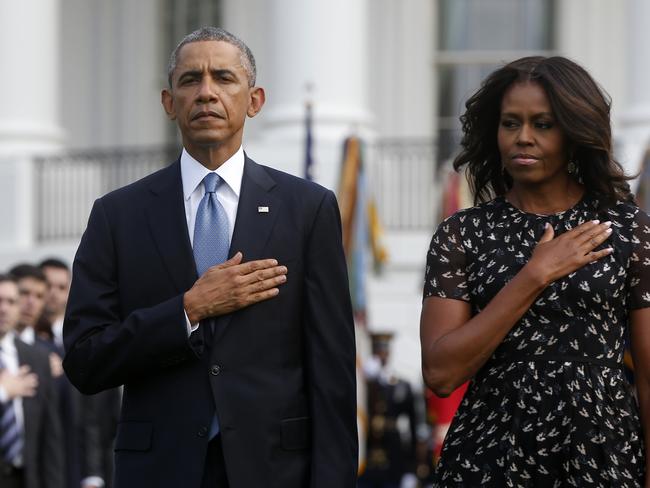 President Barack Obama and first lady Michelle Obama as they observe a moment of silence to mark the 13th anniversary of the 9/11 attacks. AP Photo/Charles Dharapak