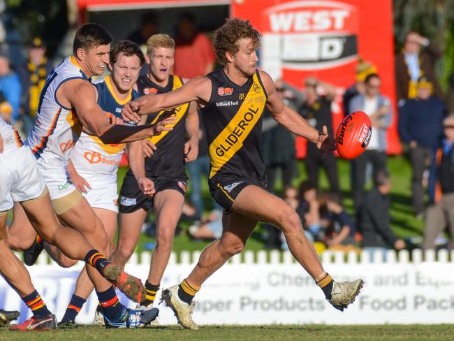 SANFL: Glenelg v Adelaide at Glenelg Oval, Saturday, May 19, 2018. Glenelgs Matthew Snook kicks under pressure.(AAP Image/ Brenton Edwards)