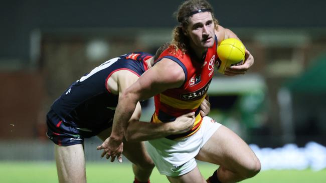 Crow Sam Berry breaks the tackle of Norwood’s Declan Hamilton in his team’s hard-fought four-goal win at the Parade. Picture: SANFL Image/David Mariuz.