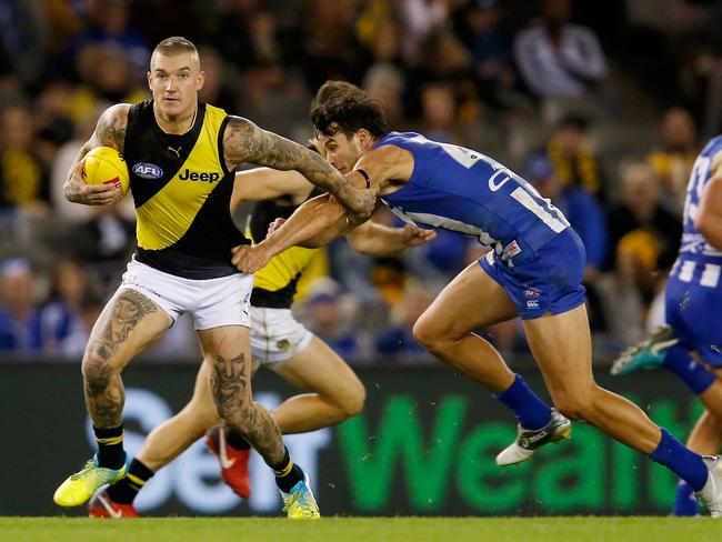 MELBOURNE, VICTORIA - MAY 13:  Dustin Martin of the Tigers runs with the ball during the round eight AFL match between the North Melbourne Kangaroos and the Richmond Tigers at Etihad Stadium on May 13, 2018 in Melbourne, Australia.  (Photo by Darrian Traynor/AFL Media/Getty Images)