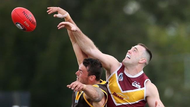 Dylan Chapman (left) wins a hitout against Lower Plenty’s Patrick Flynn. Picture: Hamish Blair