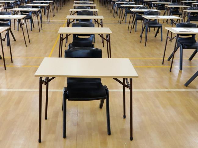 series of views of an examination hall or room images with exam tables set up ready for students. empty chairs and tables.   End of school exams university entrance or higher school certificate scene.