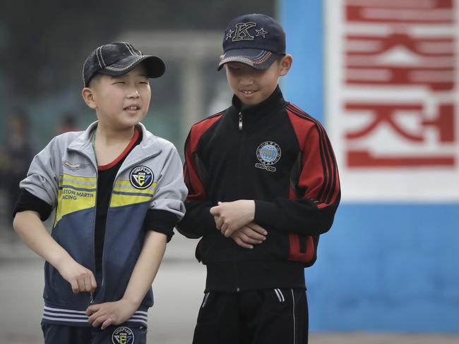 Two North Korean boys wearing baseball caps in Pyongyang. Picture: Wong Maye-E/AP