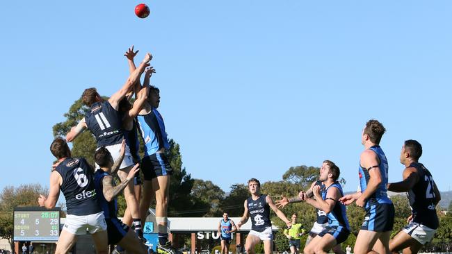 Sturt and South Adelaide players go up for a contest in their clash at Unley Oval. Picture: AAP/Emma Brasier