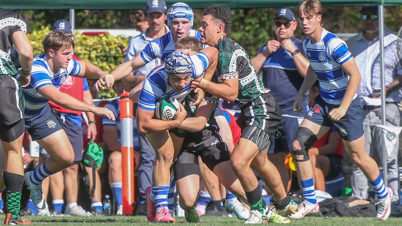 Tai Taka (green jersey) tackles Prestyn Laine-Sietu of Nudgee College. GPS First XV rugby between Nudgee College and BBC. Photo: Stephen Archer