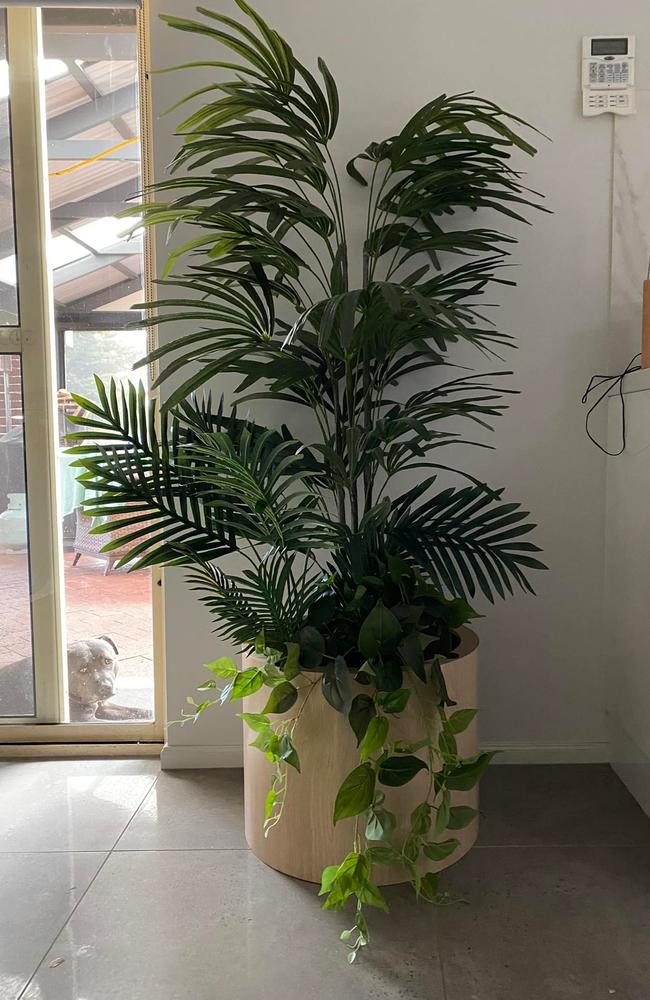 After turning it upside, it revealed a hollow interior and the woman was able to easily place a fake pot plant inside. Picture: Facebook/Kmart Inspired Homes