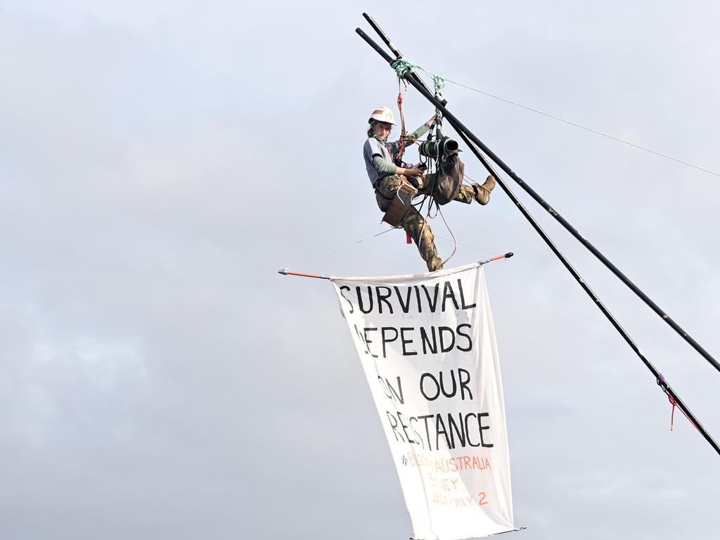 Protester Emma Dorge, who was suspended above water and across freight lines in Mascot, was eventually brought down by Police rescue and arrested. Picture: Jeremy Piper