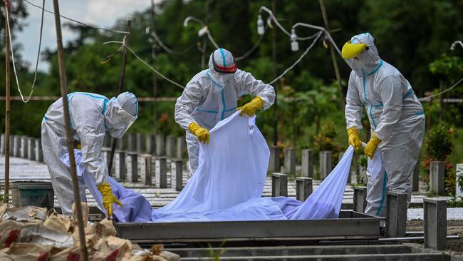 Volunteers bury the body of a COVID-19 victim in Yangon, Myanmar. Picture: AFP