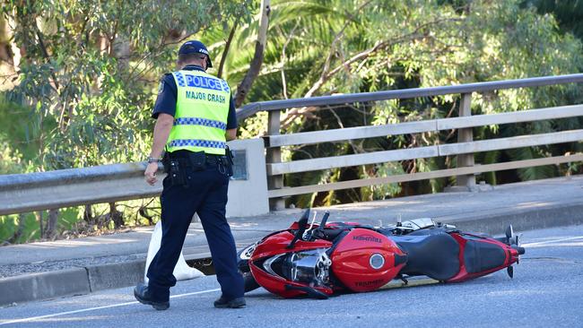 An officer inspects the motorbike involved in a fatal crash. Picture: Keryn Stevens