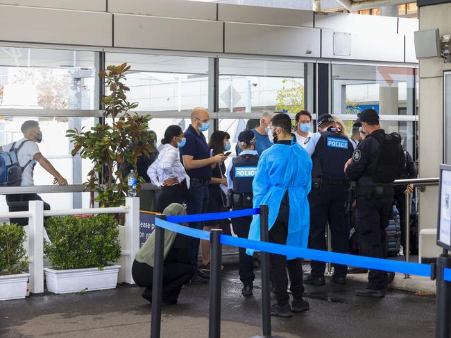 Police talk to passengers at the Histopath pre-departure Covid testing clinic at Sydney International airport. Picture: Getty