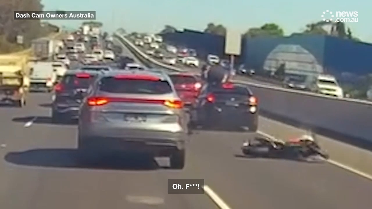 Incredible moment motorcyclist flips on top of car after crashing into it