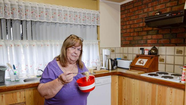 Lyn Wahlheim eats two minute noodles in her Paralowie home. Picture: Brenton Edwards