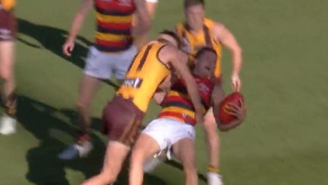 Hawthorn's Conor Nash lays a hit on Adelaide's Jake Soligo.