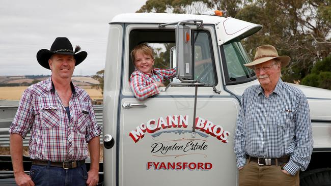 Wheels of glory: Truck and machinery collector Tom McCann, left, with son, Jock and father Bill in front of one of his many prized possessions, a 1968 International C1800 with a V8 petrol engine. Picture: Andy Rogers