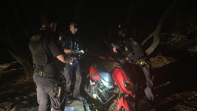 Gold Coast police examine the Yamaha 155cc moped involved in a horror late-night crash at Main Beach on the beach-edge walkway that is part of Philip Park near the Marina Mirage shopping centre turn off. A man, aged 25 to 30 and a female, 16, were injured in a collision with a light pole. PICTURE: Ryan Keen