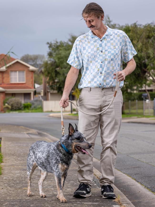 Kristian Kosh and his dog Buddy outside his Mitchell Park home. Picture: Ben Clark