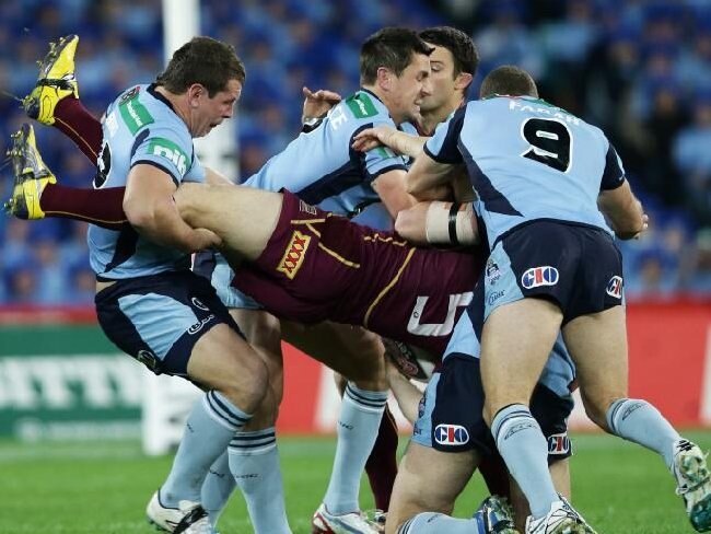 State of Origin II: Queensland's Brent Tate is swarmed over by the NSW defence. Picture: Sam Ruttyn