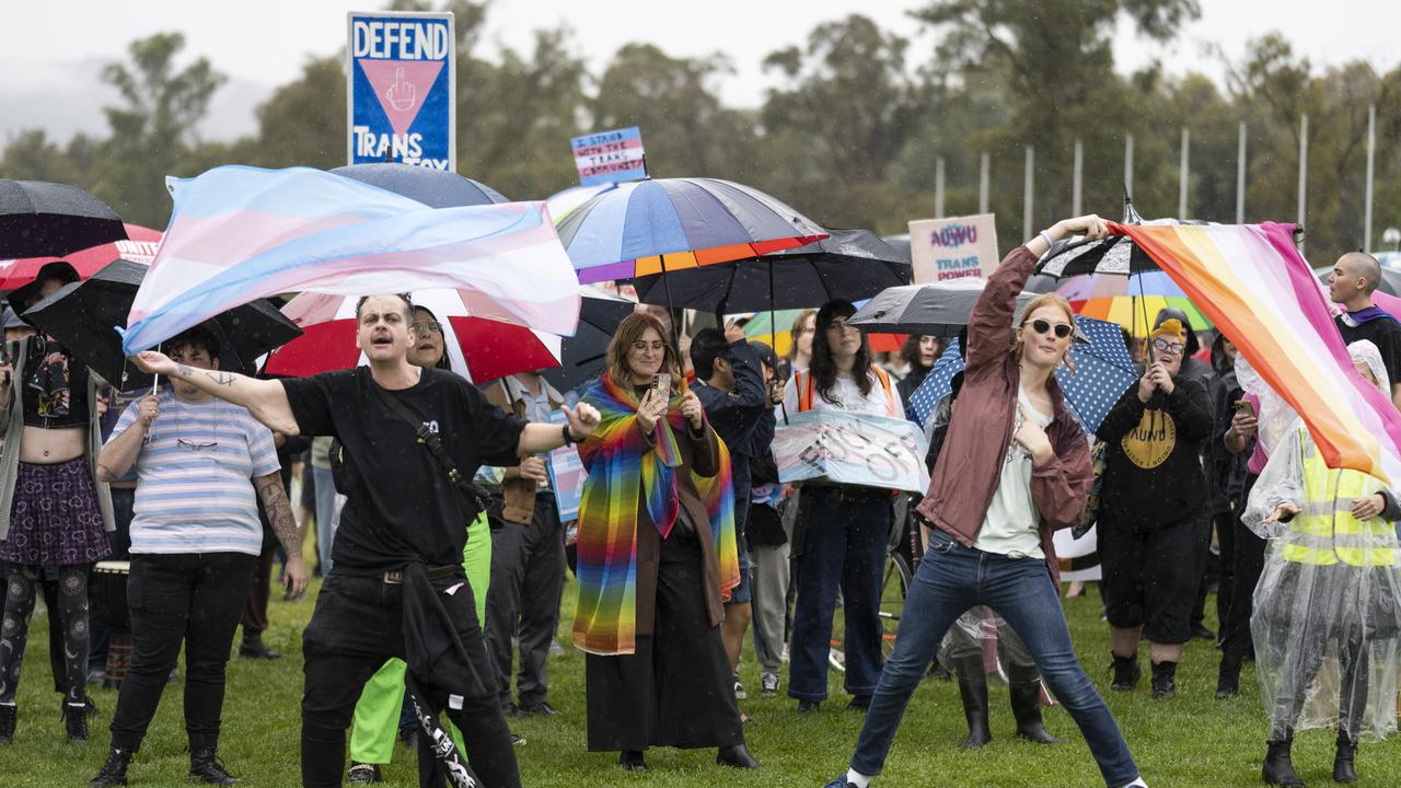 Trans activists waved flags and displayed signs. Picture: NCA NewsWire / Martin Ollman