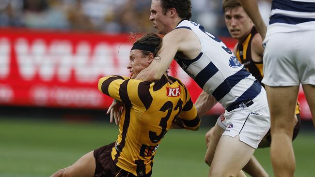 MELBOURNE , AUSTRALIA. April 1, 2024.  AFL Round 3.  Hawthorn vs Geelong at the MCG.   Jack Ginnivan of the Hawks gets takin high by Max Holmes but no free kick during the 3rd qtr.    . Pic: Michael Klein