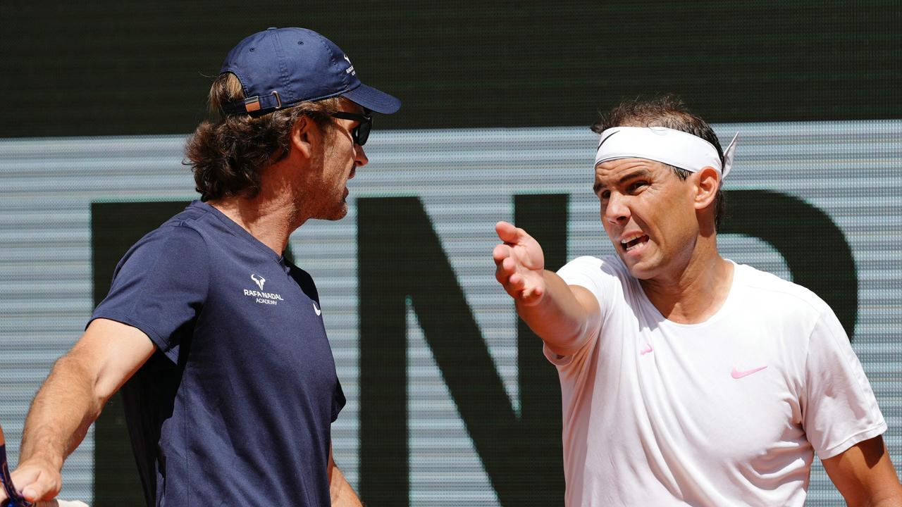 TOPSHOT - Spain's Rafael Nadal (R) speaks with his coach Carlos Moya during a practice session ahead of The French Open tennis tournament on Court Philippe-Chatrier at The Roland Garros Complex in Paris on May 21, 2024. (Photo by Dimitar DILKOFF / AFP)