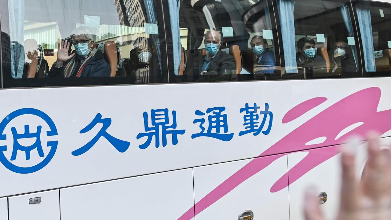 Members of the World Health Organisation (WHO) team investigating the origins of the COVID-19 coronavirus pandemic leave The Jade Hotel on a bus after completing their quarantine in Wuhan. Picture: Hector Retamal