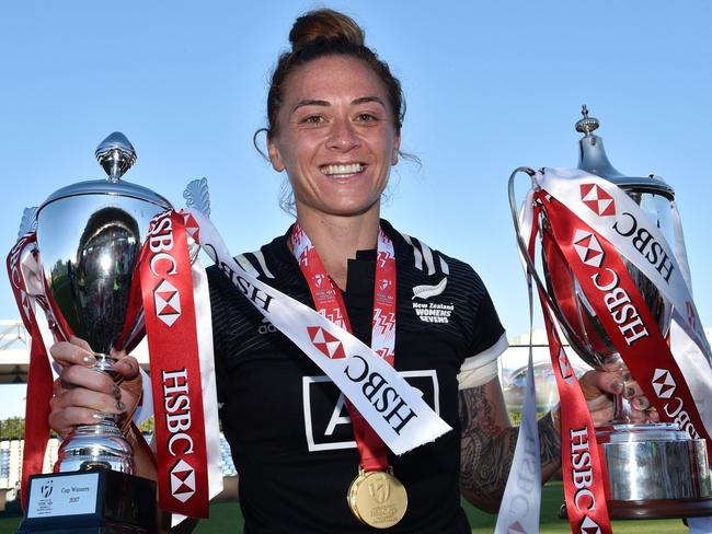 New Zealand's Niall Williams poses with a pair of trophies and her winners medal.