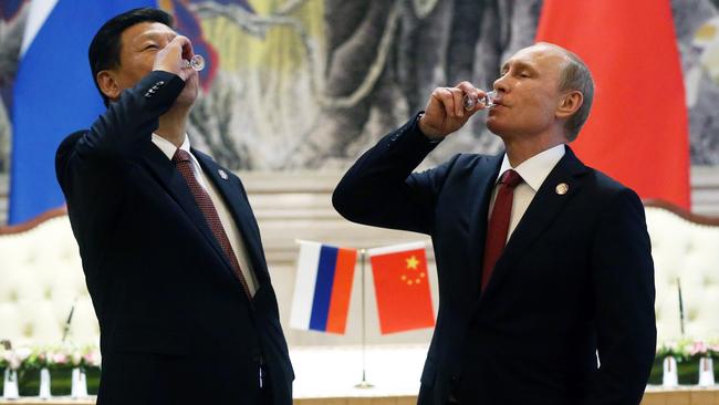 Vladimir Putin and Chinese President Xi Jinping toast after signing a thirty-year contract for supply of gas. Picture: Getty Images.