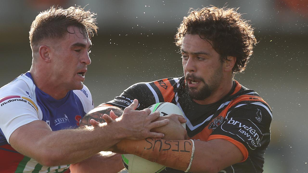 Tigers prop Josh Aloiai is being chased by the Sea Eagles.