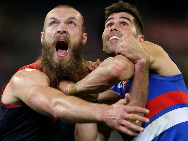 Max Gawn of the Demons (left) contests ruck against Marcus Adams of the Bulldogs during the Round 17 AFL match between the Melbourne Demons and the Western Bulldogs at the MCG in Melbourne, Saturday, July 14, 2018. (AAP Image/Hamish Blair) NO ARCHIVING, EDITORIAL USE ONLY