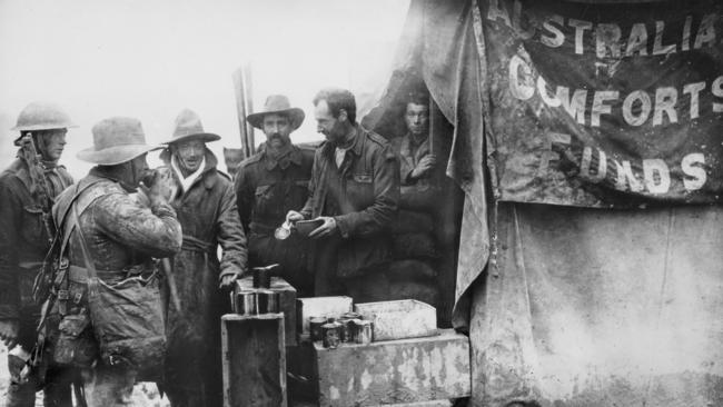 Australian soldiers take coffee break at stall behind lines at Longueval, France. Picture: Australian War Memorial