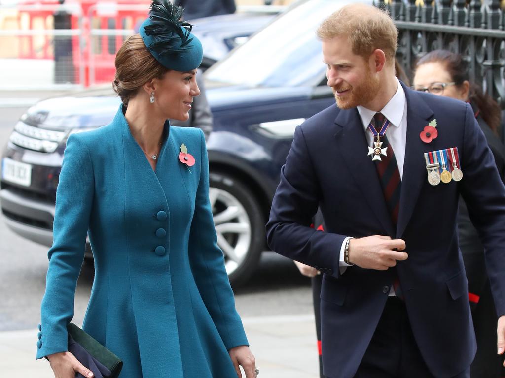 Harry, wearing his medals, and Kate were all smiles. Picture: Getty Images