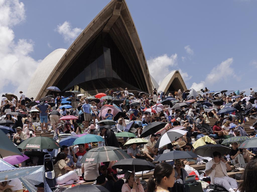 The Sydney Opera House steps were a sea of umbrellas as people tried to protect themselves from the hard sunlight. Picture: Brook Mitchell/Getty Images