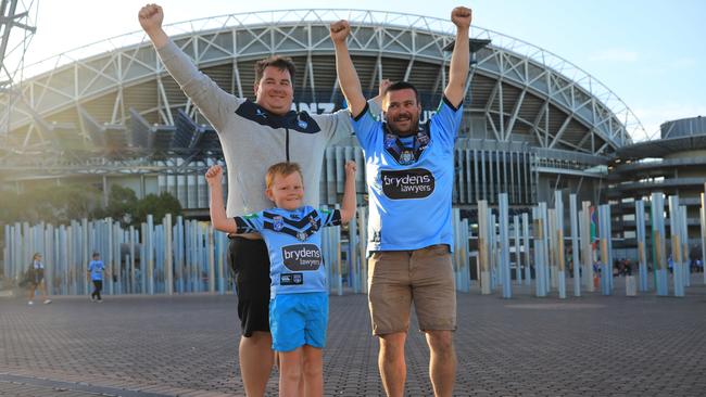 Chris Klus and his son Tyler (9) with Ethan Friend before State of Origin II. Picture: Christian Gilles